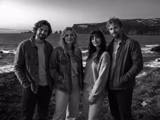 Band members on sea coast